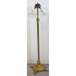 A brass Corinthian column two light standard lamp on stepped base with claw feet, height 145cm.