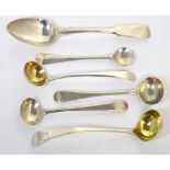 Four George III hallmarked silver ladles to include a silver gilt example and a silver gilt sifting