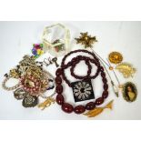 A long strand of amber graduating beads and a small quantity of costume jewellery to include