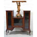 An Edwardian mahogany display cabinet of stepped form,