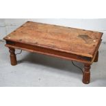 A 20th century Indian coffee table on turned legs and metal curving bracket supports, length 100cm.