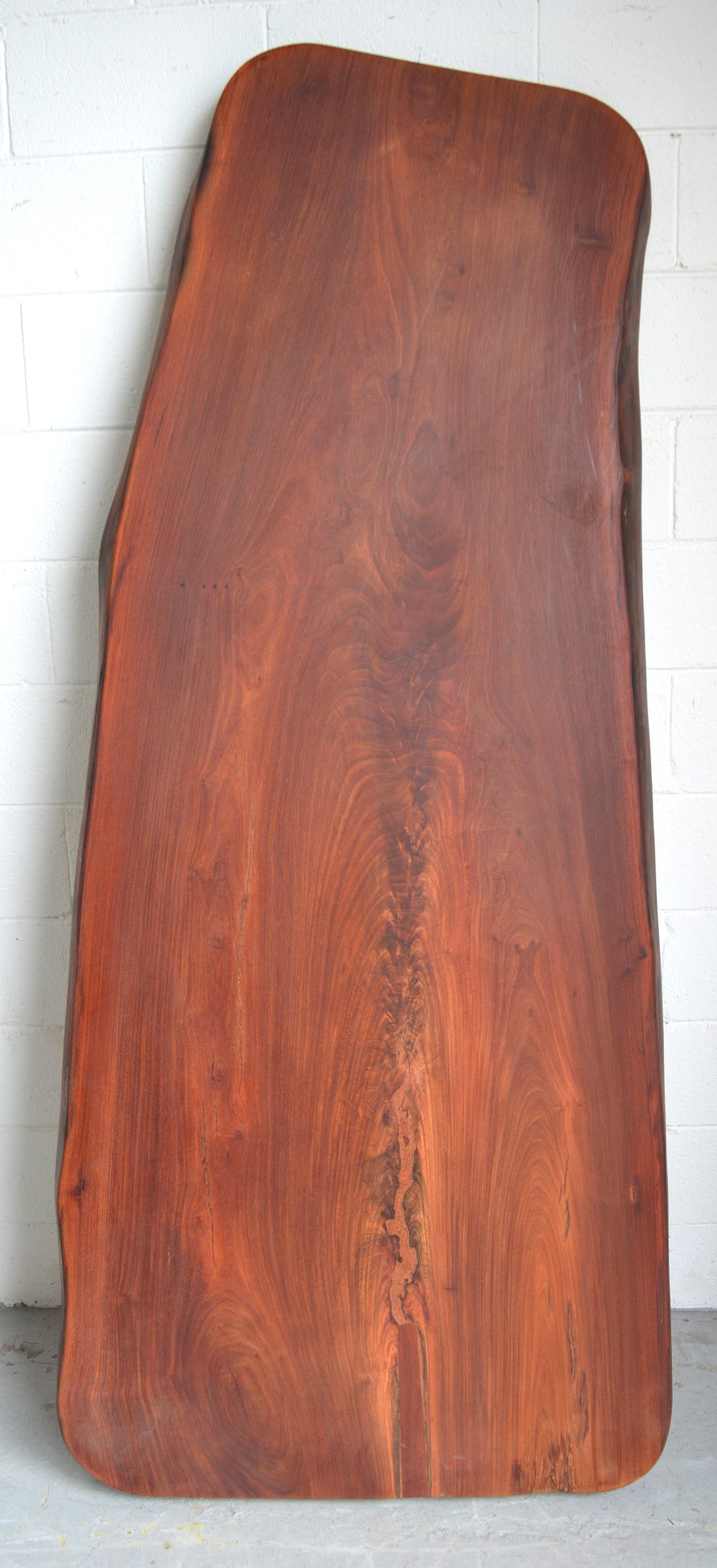 A well finished naturalistic hardwood dining table top, 215 x 75cm.