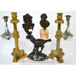 A pair of Art Nouveau style pewter candlesticks, a larger pair of ornate brass candlesticks,