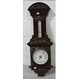 An early 20th century carved oak wall mounted barometer/thermometer, by Sharman D Neill Ltd,