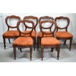 Six Victorian mahogany balloon back dining chairs on turned legs and peg feet (6).