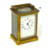 A French brass carriage clock, the dial set with Roman numerals,