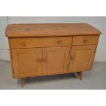 A pale oak sideboard with two drawers and two cupboard doors.