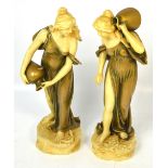 A pair of porcelain female water carriers with gilt heightened clothing and vessels,