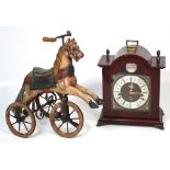 A reproduction thirty hour mantel clock, the silvered dial set with Roman numerals,