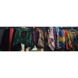 A large quantity of vintage clothes to include many crushed velvet skirts and tops, a straw hat etc.