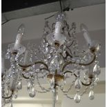 A six branch gilt metal and cut glass chandelier, height approx 70cm.