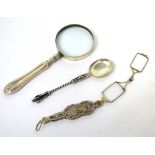 A white metal apostle spoon, a magnifying glass with hallmarked silver handle, marks rubbed,