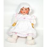 An Armand Marseille bisque head doll with glass eyes,