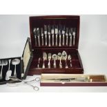 A silver plated canteen of silver plated cutlery, a boxed three piece silver plated serving set,