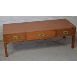 A teak and brass bound military style rectangular coffee table,