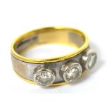 A gentleman's 18ct white and yellow gold ring set with three round brilliant cut diamonds,