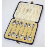 A cased set of George V hallmarked silver teaspoons with enamel Art Deco finial,