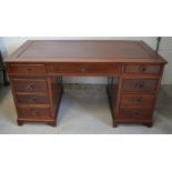 A Chinese hardwood nine drawer pedestal desk, width of top 152cm.