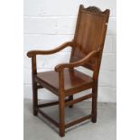 A solid walnut armchair on block supports with conjoining stretcher.