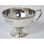 A George V hallmarked silver cup on pedestal base with inscription 'Jack Ashley Moores from his