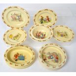 A collection of Royal Doulton Bunnykins by Barbara Vernon to include an oval baby's plate,