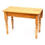 A Victorian pine kitchen Pembroke table with single leaf on four turned legs and drawer to one end,
