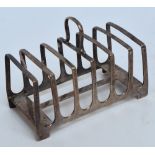 A George V hallmarked silver silver six division toast rack of plain rectangular form with central