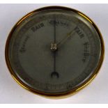An early 20th century brass cased barometer with silvered dial, diameter 13.5cm.