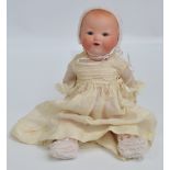 A small German Armand Marseille bisque headed doll with open/close eyes and open mouth revealing