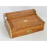 A 19th century mahogany campaign writing slope with hinged fall front beneath a tambour roll