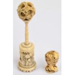 A late 19th century Chinese carved bone puzzle ball on stand, height 12cm,