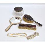 A George V hallmarked silver mounted tortoiseshell backed dressing table set comprising hand mirror,