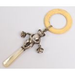 A hallmarked silver teething rattle in the form of a double fronted teddy bear with two bells,
