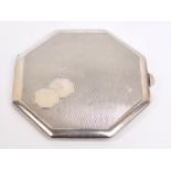 A George VI hallmarked silver octagonal powder compact with overall engine turned decoration,