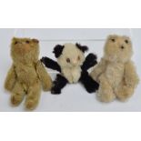 Three early 20th century miniature teddy bears; a real fur panda, height 7cm,