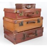 A small collection of vintage suitcases, two faux leather and one leather covered,