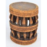 A 20th century African tribal stool with circular top and pierced frame, height 29cm.