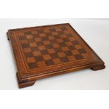 An early 20th century chess board made from specimen woods with stringing and crossbanding,