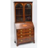 An Edwardian mahogany and satinwood inlaid bureau bookcase with glazed upper section above fall
