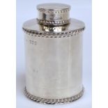 A late Victorian hallmarked silver tea caddy of circular form with two bands of wrythen moulded