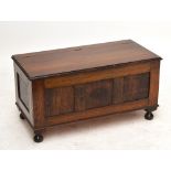 A small oak blanket box with hinged lid above panelled front and four bun feet, width 91.5cm.