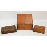 An Edwardian oak stationery box with sloping twin door front and compartmentalised interior above