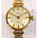 HEFIK; a lady's vintage 9ct gold wristwatch with circular dial and openwork bracelet,