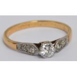 A yellow metal diamond ring, the claw set principle stone measuring approx 0.