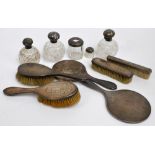 A George V hallmarked silver backed three piece dressing table set comprising a circular hand