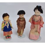 Three 1920s Japanese dolls, largest with papier-mâché head and glass inset eyes,