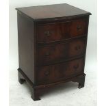 A small reproduction mahogany bowfronted three drawer chest raised on bracket feet, width 52cm.