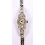 VERTEX; an Art Deco platinum cased manual wind lady's cocktail wristwatch of lobed form,