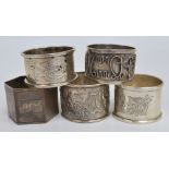 A group of five napkin rings comprising variously hallmarked English silver examples,