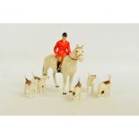 A Beswick huntsman on horseback with five assorted hounds.